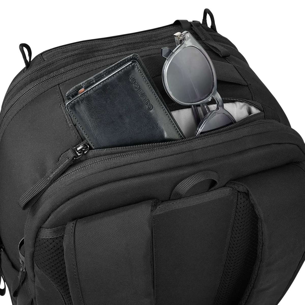 Quick-access pockets holding a wallet and sunglasses
