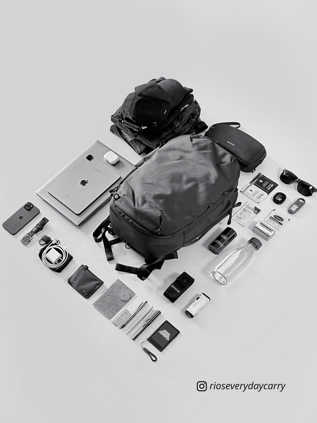 Daily Dash backpack laid out with everyday essentials. Accessories shown are not included.
