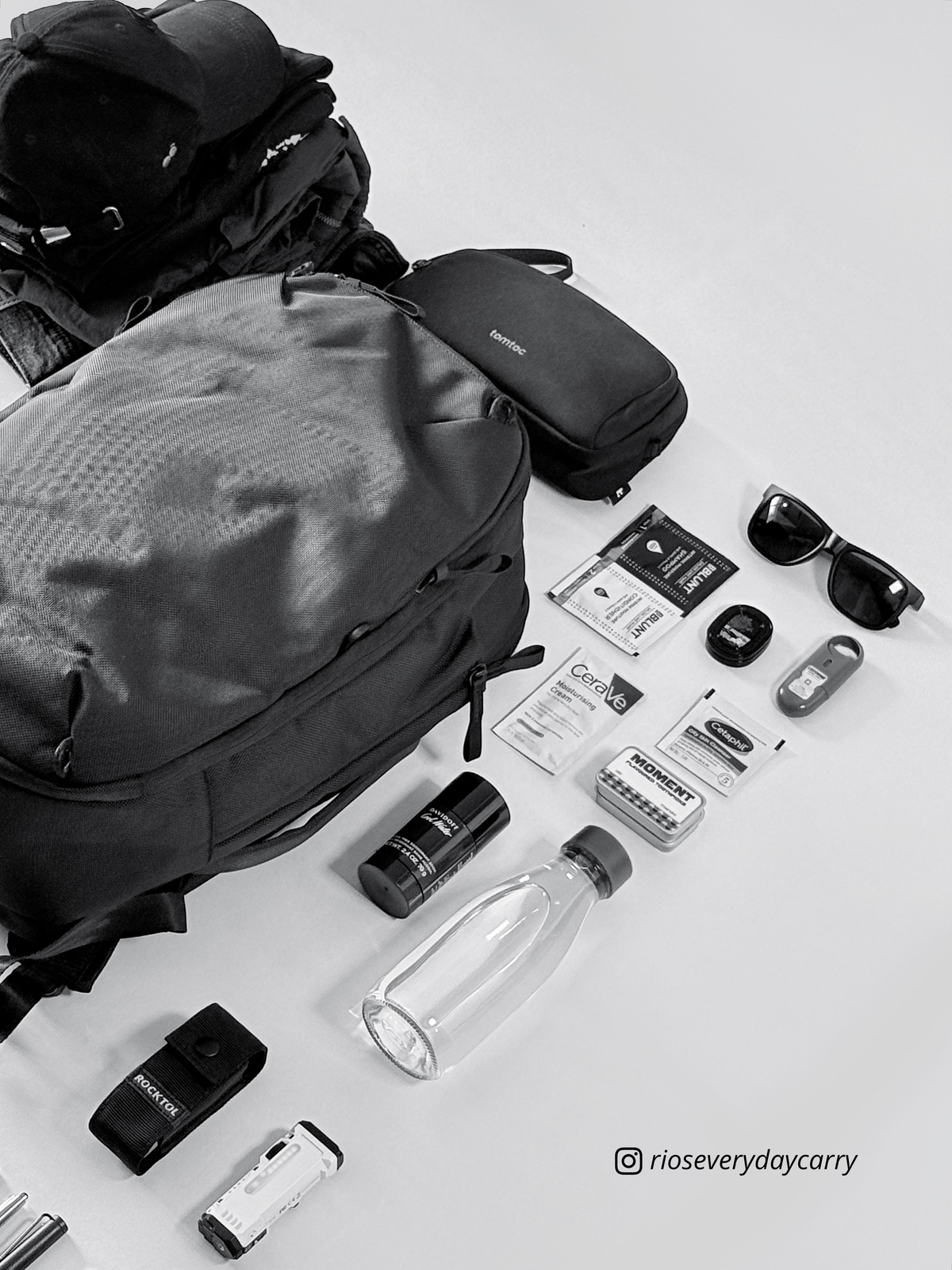 Black and white close flatlay of Daily Dash beside personal essentials