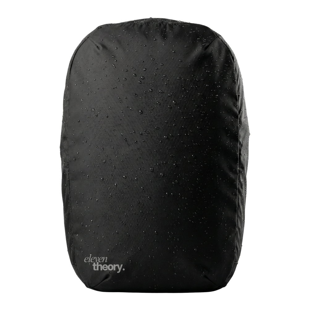 Black backpack with water droplets on a white background, featuring 'eleven theory' branding.