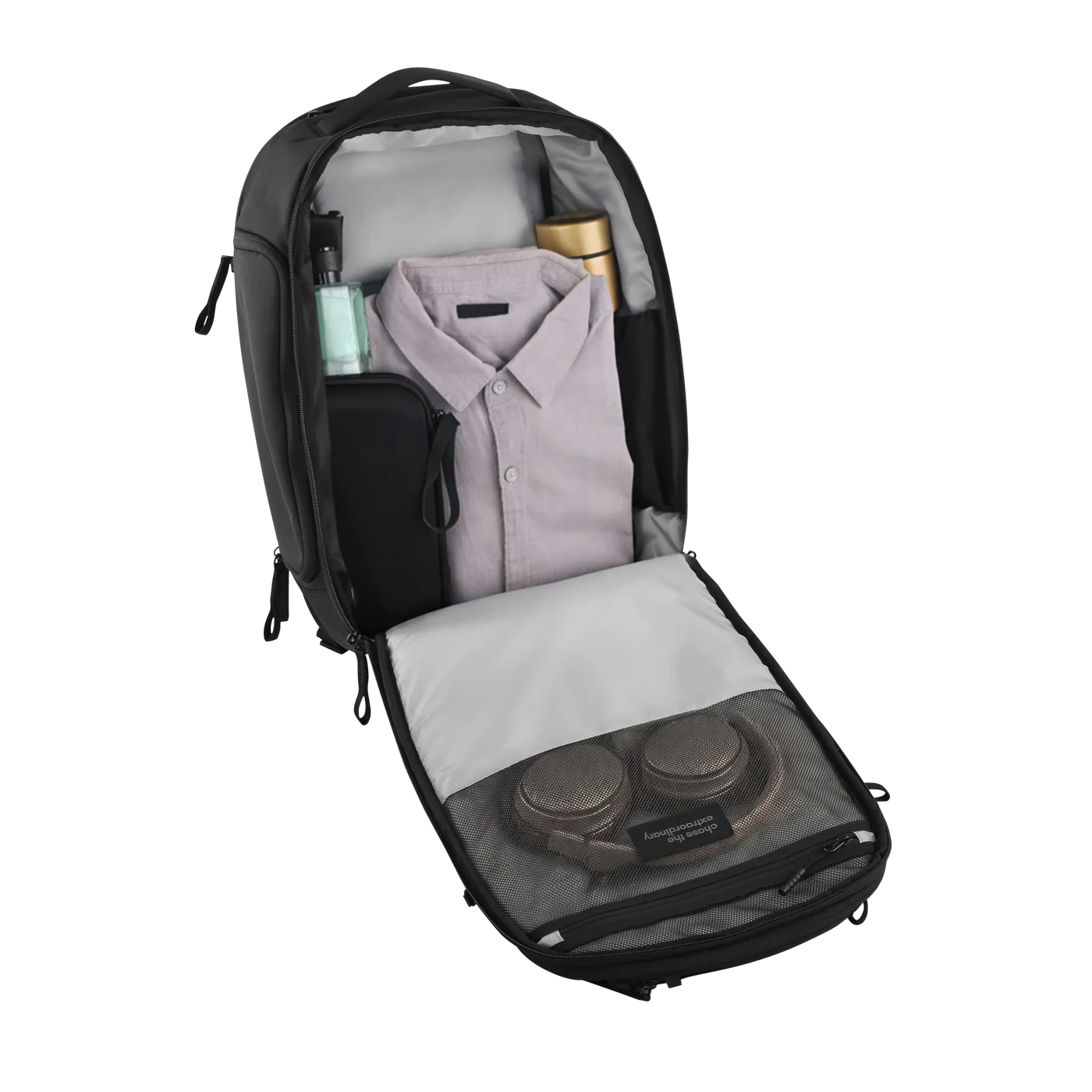 Open Daily Dash packed with clothing, a bottle and headphones